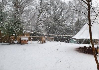 Huckleberries base camp covered in snow with large snowflakes falling